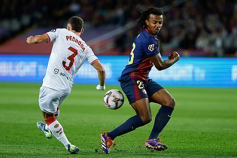 La Liga 2024-25: Barcelona's Jules Kounde, right, duels for the ball with Sevilla's Adria Pedrosa