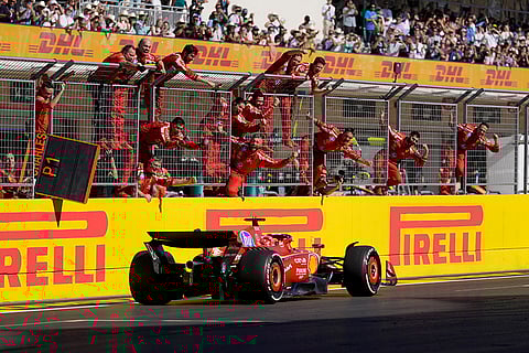 U.S. Grand Prix: Team members stand along the fence celebrating as Ferrari driver Charles Leclerc wins race