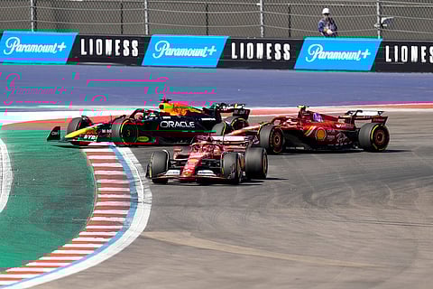 U.S. Grand Prix: Ferrari drivers Charles Leclerc, Carlos Sainz and Red Bull driver Max Verstappen steer wide through a turn to avoid colliding