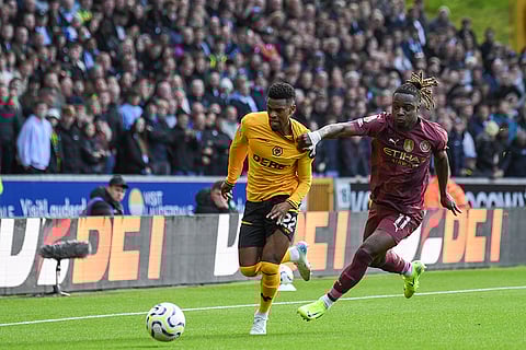 EPL 2024-25: Manchester City's Jeremy Doku, right, challenges Wolverhampton Wanderers' Nelson Semedo