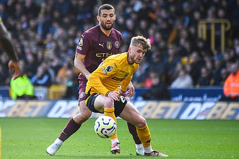 EPL 2024-25: Wanderers' Tommy Doyle, front, is challenged by Manchester City's Mateo Kovacic