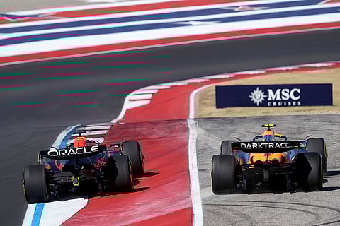 U.S. Grand Prix: Red Bull driver Max Verstappen, left runs McLaren driver Lando Norris, right, of Britain, off the track at Turn 1