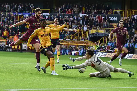 EPL 2024-25: Manchester City's goalkeeper Ederson, bottom, blocks a shot by Wolverhampton Wanderers' Nelson Semedo