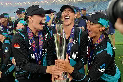 Women's T20 WC 2024 Final: New Zealand's captain Sophie Devine, center, poses with teammates Lea Tahuhu, left, and Suzie Bates