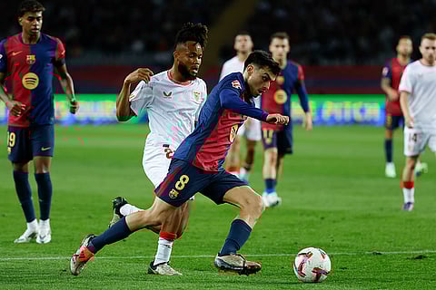 La Liga 2024-25: Barcelona's Pedri, front, duels for the ball with Sevilla's Chidera Ejuke
