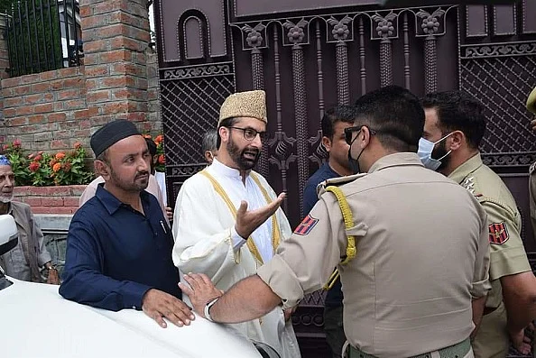 Hurriyat Conference chairman Mirwaiz Umar Farooq being stopped by police personal.