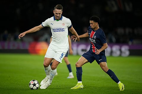 Champions League 2024-25: PSV's Luuk de Jong, left, evades PSG's Warren Zaire-Emery