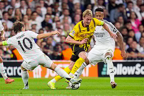Champions League 2024-25: Dortmund's Julian Brandt, center, vies for the ball with Real Madrid's Luka Modric, left, and Eder Militao