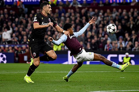 Champions League 2024-25: Aston Villa's Leon Bailey, right, fights for the ball against Bologna's Charalampos Lykogiannis