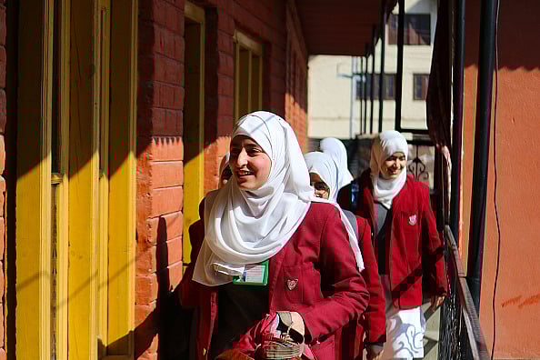 Getty Images : Students walk towards their classrooms following a two-month-long winter break in Srinagar (March 04, 2024) |