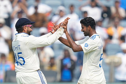 India Vs New Zealand 2nd Test: India's Washington Sundar, right, and Rohit Sharma celebrates the dismissal of New Zealand's Rachin Ravindra