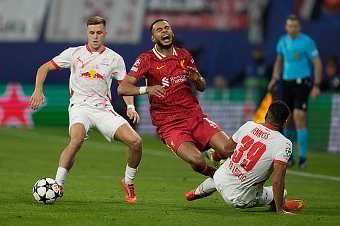 Champions League 2024-25: Liverpool's Cody Gakpo, center, duels for the ball with Leipzig's Christoph Baumgartner