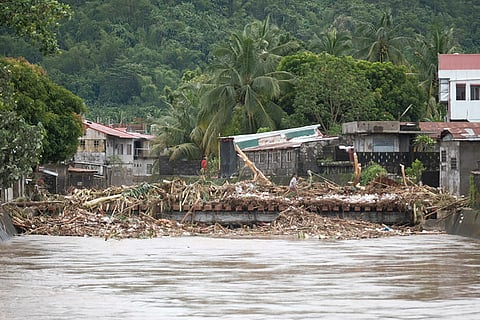 Tropical Storm Trami: Debris from damages are gathered along a bridge after floods