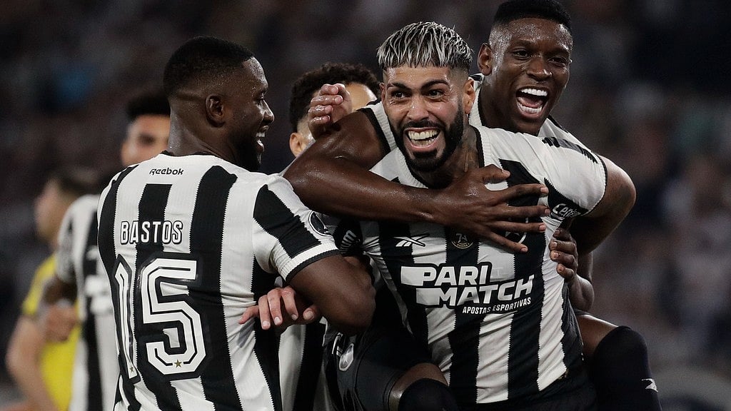 AP/Bruna Prado : Alexander Barboza of Brazil's Botafogo, right, celebrates with teammates after scoring his side's second goal against Uruguay's Penarol during a Copa Libertadores semifinal first leg.