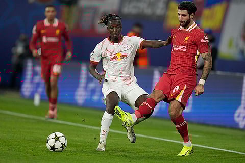 Champions League 2024-25: Liverpool's Dominik Szoboszlai, right, duels for the ball with Leipzig's Amadou Haidara