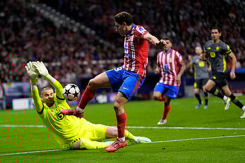 Champions League 2024-25: Lille's goalkeeper Lucas Chevalier, left, makes a save against Atletico Madrid's Julian Alvarez