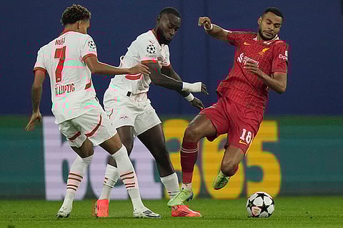 Champions League 2024-25: Liverpool's Cody Gakpo, right, duels for the ball with Leipzig's Lutsharel Geertruida