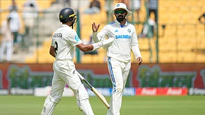 AP Photo/Aijaz Rahi : India's K.L. Rahul, right, congratulates New Zealand's Rachin Ravindra at the end of New Zealand innings during the day three of the first cricket test match between India and New Zealand at the M.Chinnaswamy Stadium, in Bengaluru.