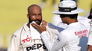 AP/Anjum Naveed : Umpire Sharfuddoula, right, wipes the blood off Sajid Khan's chin after the latter was hit by a ball during the day two of third Test between Pakistan and England in Rawalpindi.
