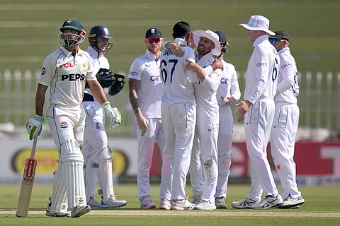 Pakistan vs England 3rd Test: England's Shoaib Bashir, center, celebrates with teammates after taking the wicket of Pakistan's Shan Masood