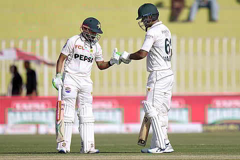 Pakistan vs England 3rd Test: Pakistan's Saud Shakeel, left, and Noman Ali bumps their thumbs during the day two