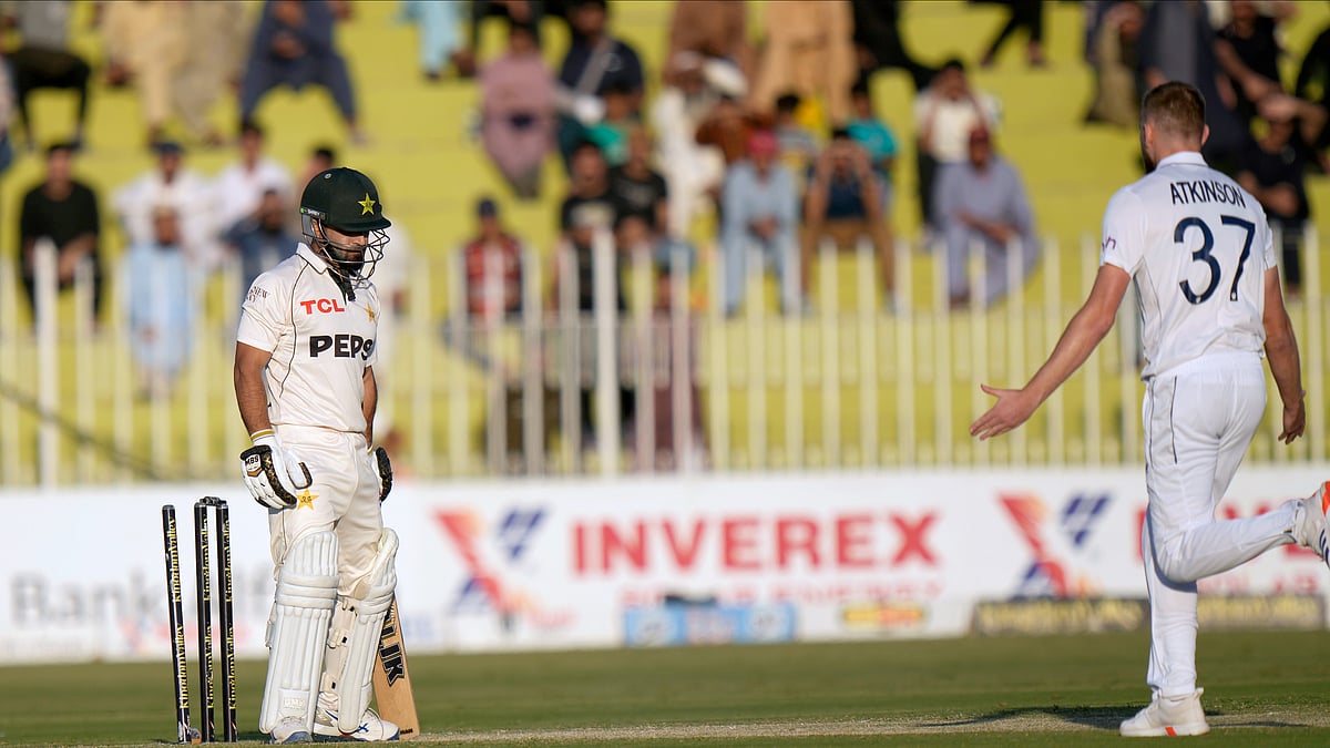 AP Photo/Anjum Naveed : Pakistan's Kamran Ghulam, left, reacts as he is bowled out by England's Gus Atkinson, right, during day one of the third test cricket match between Pakistan and England, in Rawalpindi.
