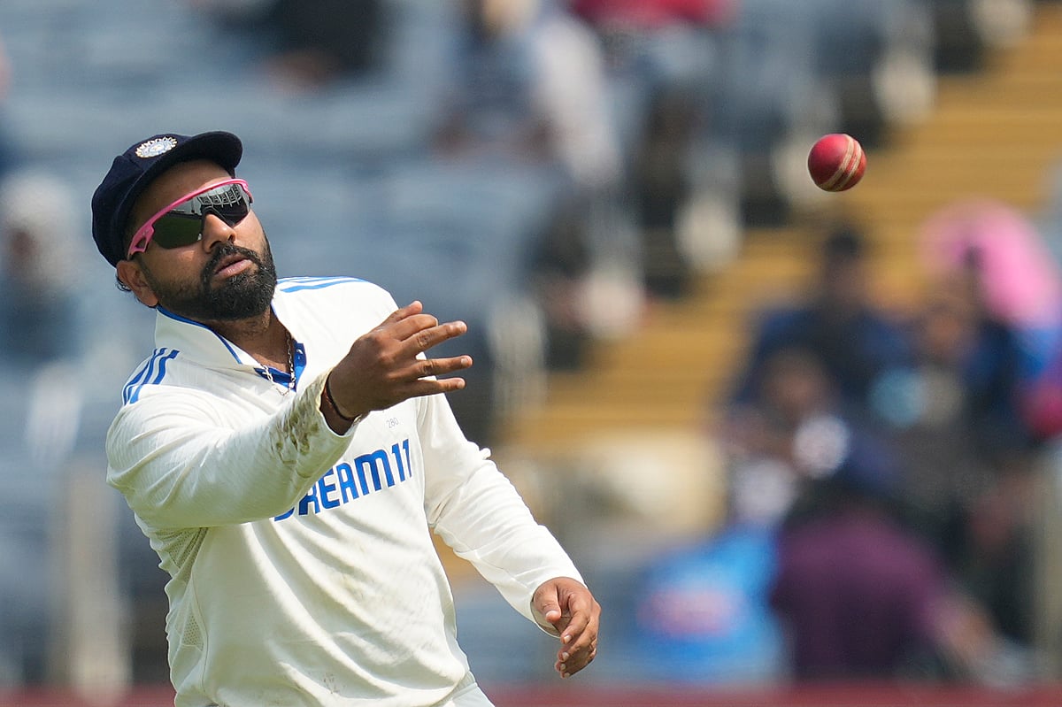 India's captain Rohit Sharma throws the ball during the day one of the second cricket test match between India and New Zealand at the Maharashtra Cricket Association Stadium , in Pune, India, Thursday, Oct. 24, 2024.  - (AP Photo/Rafiq Maqbool)