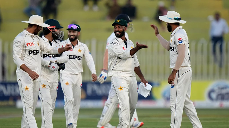 Pakistans Sajid Khan, second right, and teammates walk off the field. AP Photo