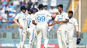 AP Photo/Rafiq Maqbool : India's Washington Sundar, right, celebrates the dismissal of New Zealand's Daryl Mitchell with his team mates during day two of the second cricket test match between India and New Zealand at the Maharashtra Cricket Association Stadium, in Pune.