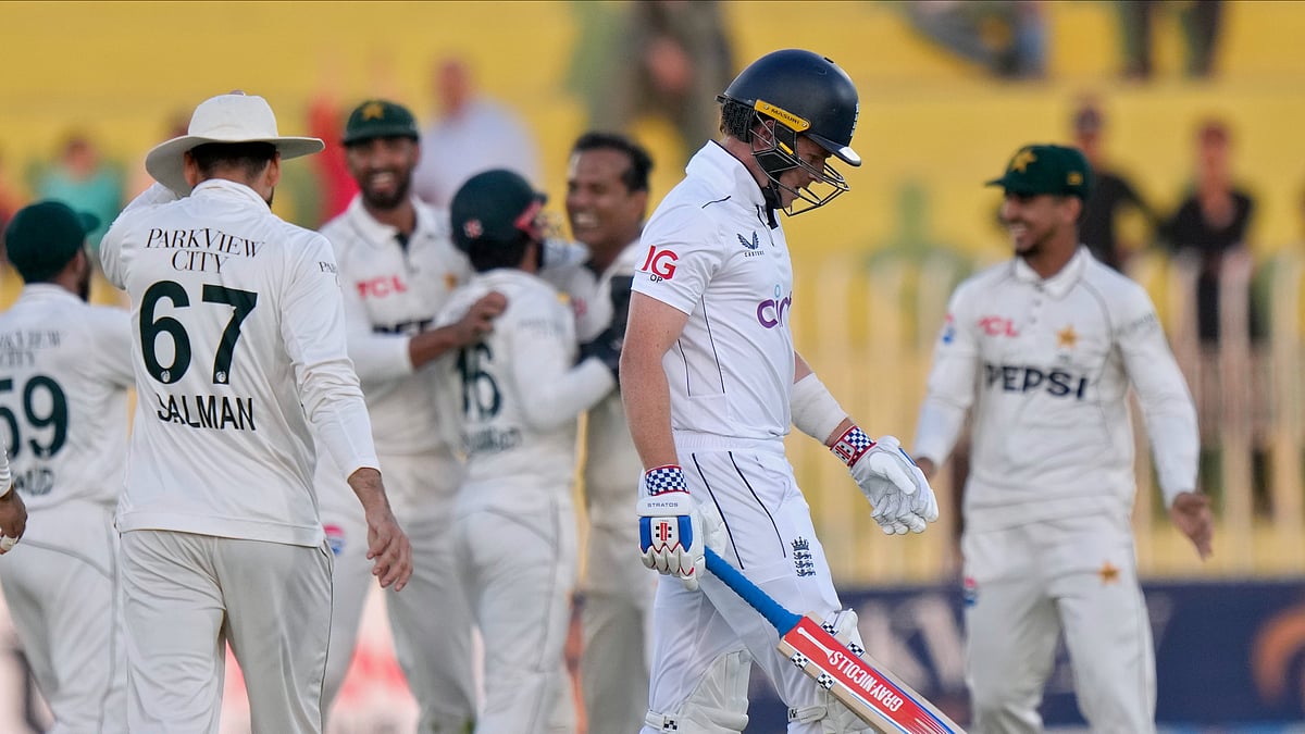 AP Photo/Anjum Naveed : England's Ollie Pope, second right, reacts as he walks off the field after his dismissal during day two of the third test cricket match between Pakistan and England, in Rawalpindi.