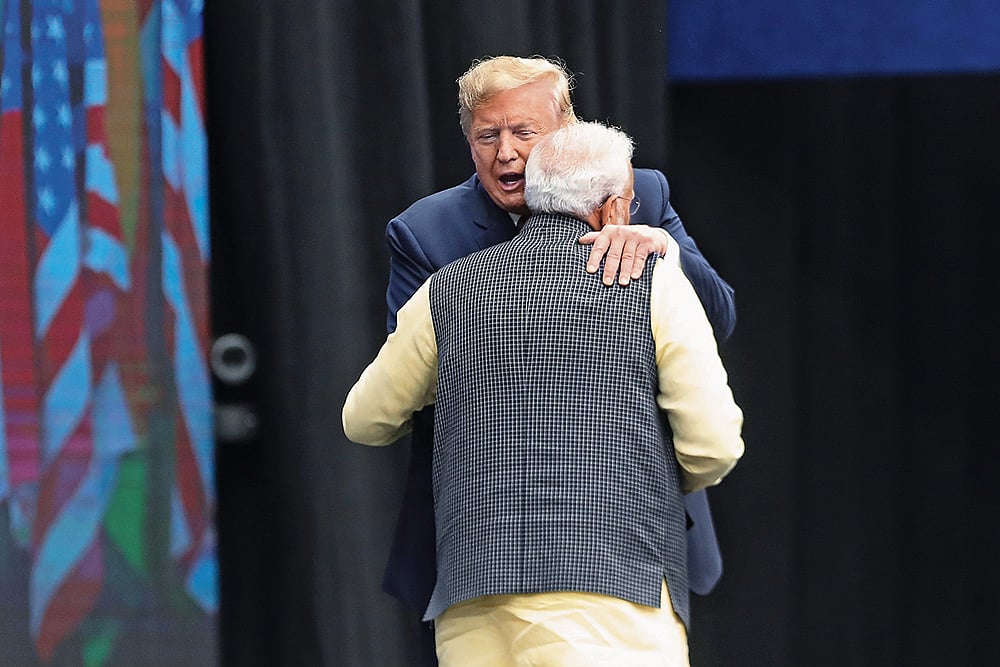 Photo: Getty Images : Fostering Ties: Indian Prime Minister Narendra Modi and then US President Donald Trump embrace during the Howdy Modi event at NRG Stadium on September 22, 2019, in Houston, USA