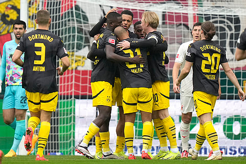 Bundesliga soccer: Dortmund's Donyell Malen, centre, celebrates with teammates after scoring his side's opening goal