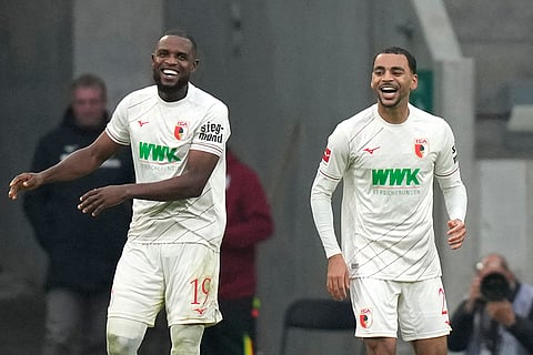 Bundesliga soccer: Augsburg's Alexis Claude-Maurice, right, celebrates with teammates Augsburg's Frank Onyeka after scoring his side's second goal