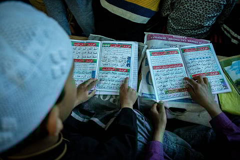 Kashmiri Muslim children read the holy Quran at a local madrasa, or Muslim religious school, during the holy month of Ramadan. Muslims throughout the world are marking the month of Ramadan, where observants fast from dawn till dusk.