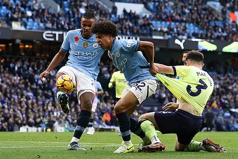 EPL 2024-25: Southampton's Ryan Manning, right, duels for the ball with Manchester City's Rico Lewis, center, and Manuel Akanji
