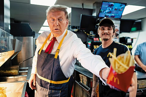 At Your Service: Trump works behind the counter during a campaign event at McDonald’s in Pennsylvania