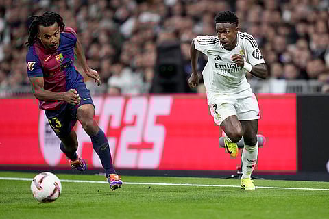 La Liga 2024-25: Barcelona's Jules Kounde fights for the ball against Real Madrid's Vinicius Junior