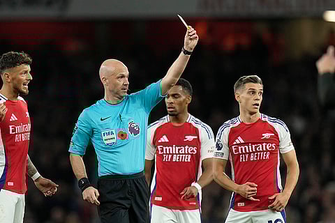 Premier League 2024-25: Referee Anthony Taylor shows a yellow card to Liverpool's Alexis Mac Allister