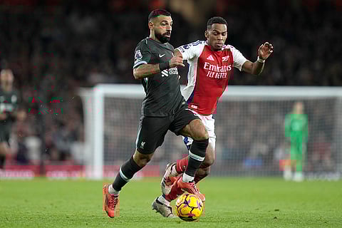 Premier League 2024-25: Liverpool's Mohamed Salah, left, challenges for the ball with Arsenal's Jurrien Timber