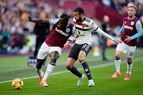 Premier League 2024-25: West Ham United's Michail Antonio, left, and Manchester United's Noussair Mazraoui battle for the ball
