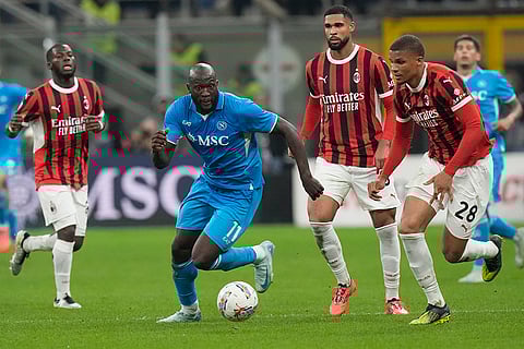 Serie A 2024-25: Napoli's Romelu Lukaku, centre, controls the ball ahead AC Milan's Malick Thiaw
