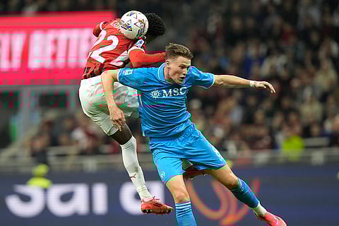 Serie A 2024-25: AC Milan's Emerson Royal, left, challenges for the ball with Napoli's Scott McTominay