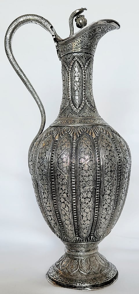 An intricately carved and embossed solid silver 'Surahi'. Mid to late 1800s. Notice the distinctly Kashmiri snake handle