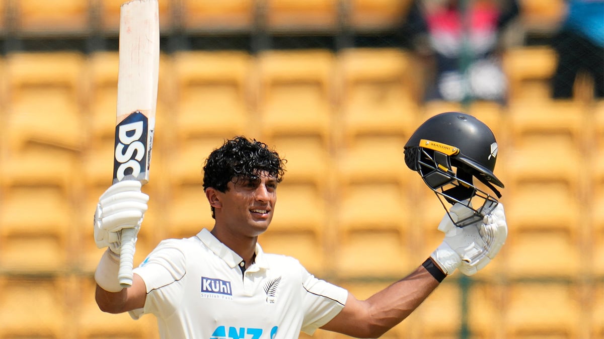 (AP Photo/Aijaz Rahi) : New Zealand's Rachin Ravindra celebrates after scoring a century during the day three of the first cricket test match between India and New Zealand at the M.Chinnaswamy Stadium, in Bengaluru, India, Friday, Oct. 18, 2024. 