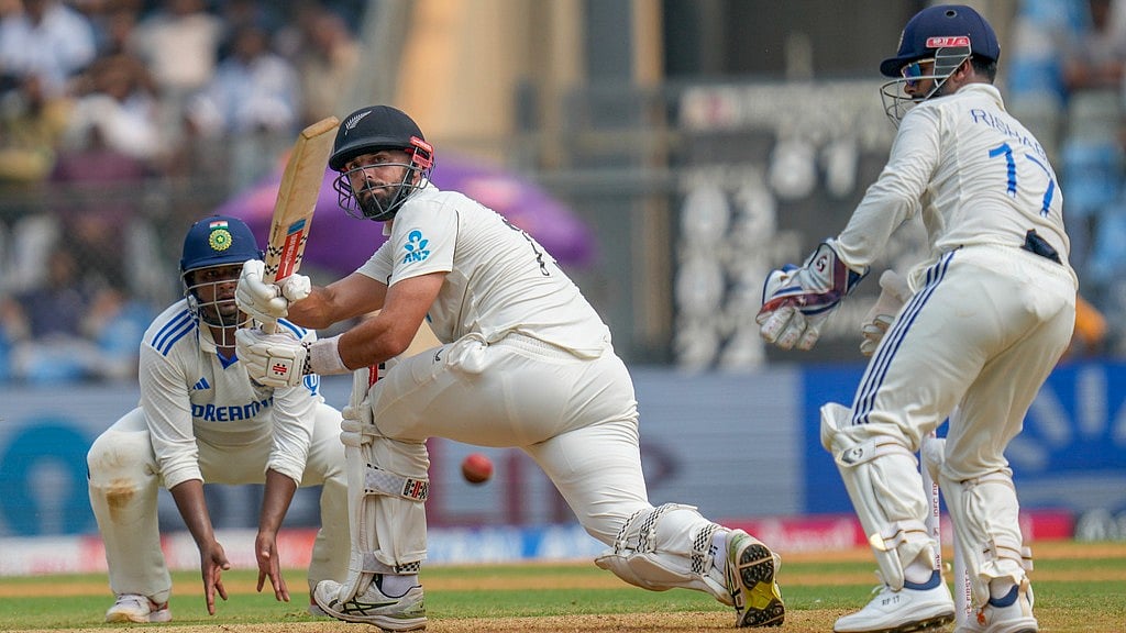 AP : Daryl Mitchell watches at the ball after playing a shot during the first day of the third Test between India and New Zealand at Wankhede Stadium.