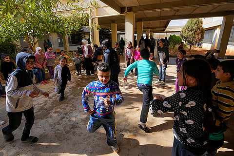 Displaced children play at a school being used as a shelter, in Deir Al-Ahmar