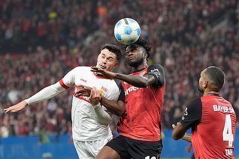 Bundesliga soccer 2024-25: Stuttgart's Fabian Rieder, left, challenges for the ball with Leverkusen's Edmond Tapsoba