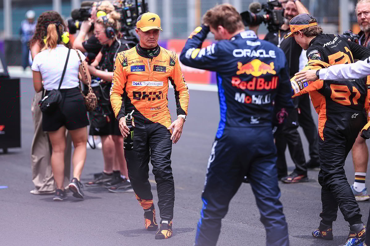 (AP Photo/Ettore Chiereguini) : McLaren driver Lando Norris of Britain, left, walks on the track after setting the fastest time in the sprint race ahead of the Brazilian Formula One Grand Prix auto race at the Interlagos racetrack in Sao Paulo, Saturday, Nov. 2, 2024.