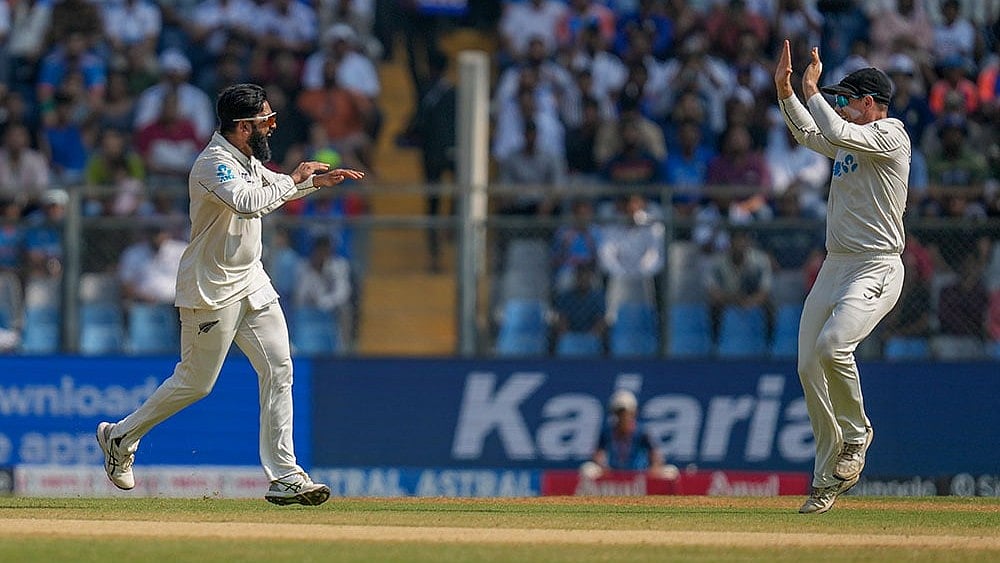 | Photo: AP/Rajanish Kakade : NZ vs IND 3rd Test: Ajaz Patel (left) celebrates a wicket with skipper Tom Latham.