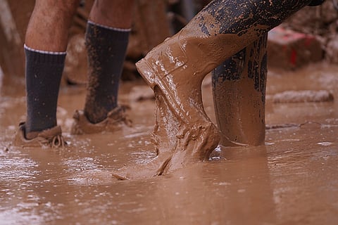 Spain Floods: People walk in the mud near Valencia